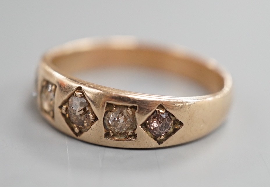 An early 20th century yellow metal and gypsy set graduated five stone diamond half hoop ring, size Q. gross weight 3.6 grams.
